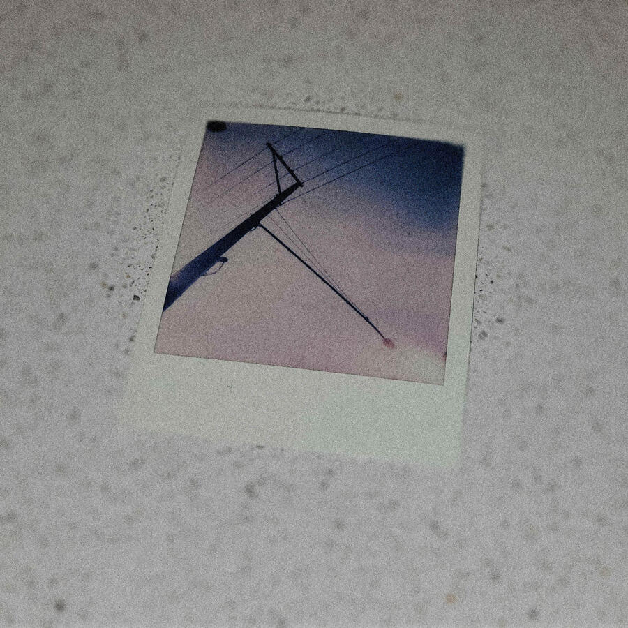 A printed photo of a street light and power lines on a countertop.